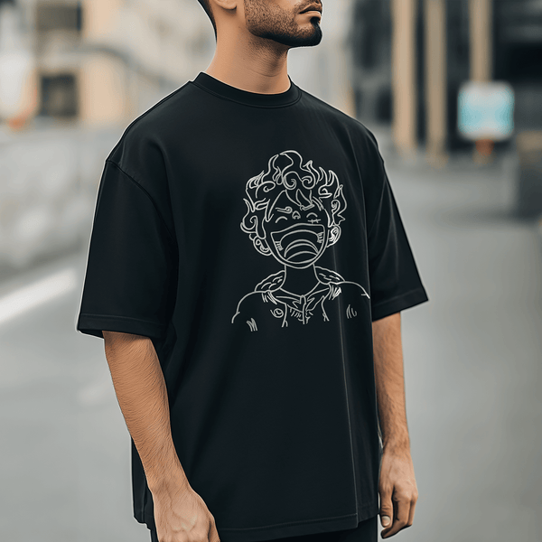 Embroidered Oversized T-Shirts India featuring a character design on a black t-shirt worn by a young man.